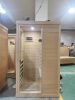 Hemlock Mini one person far infrared door on the left of the indoor sauna room