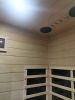Hemlock Mini one person far infrared door on the left of the indoor sauna room